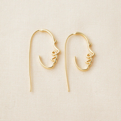 Gold-plated face earrings