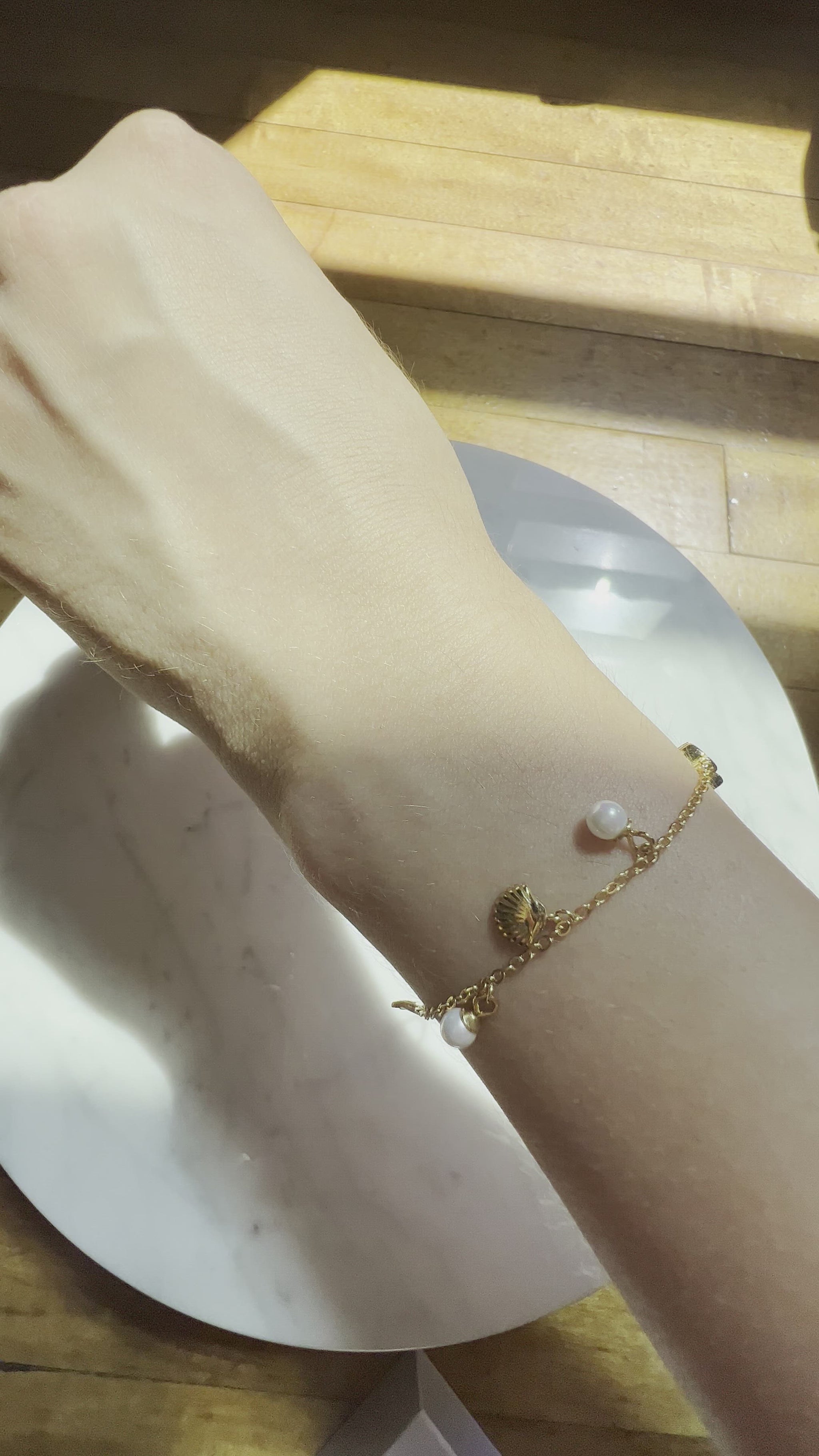video displaying ocean charm bracelet on model
