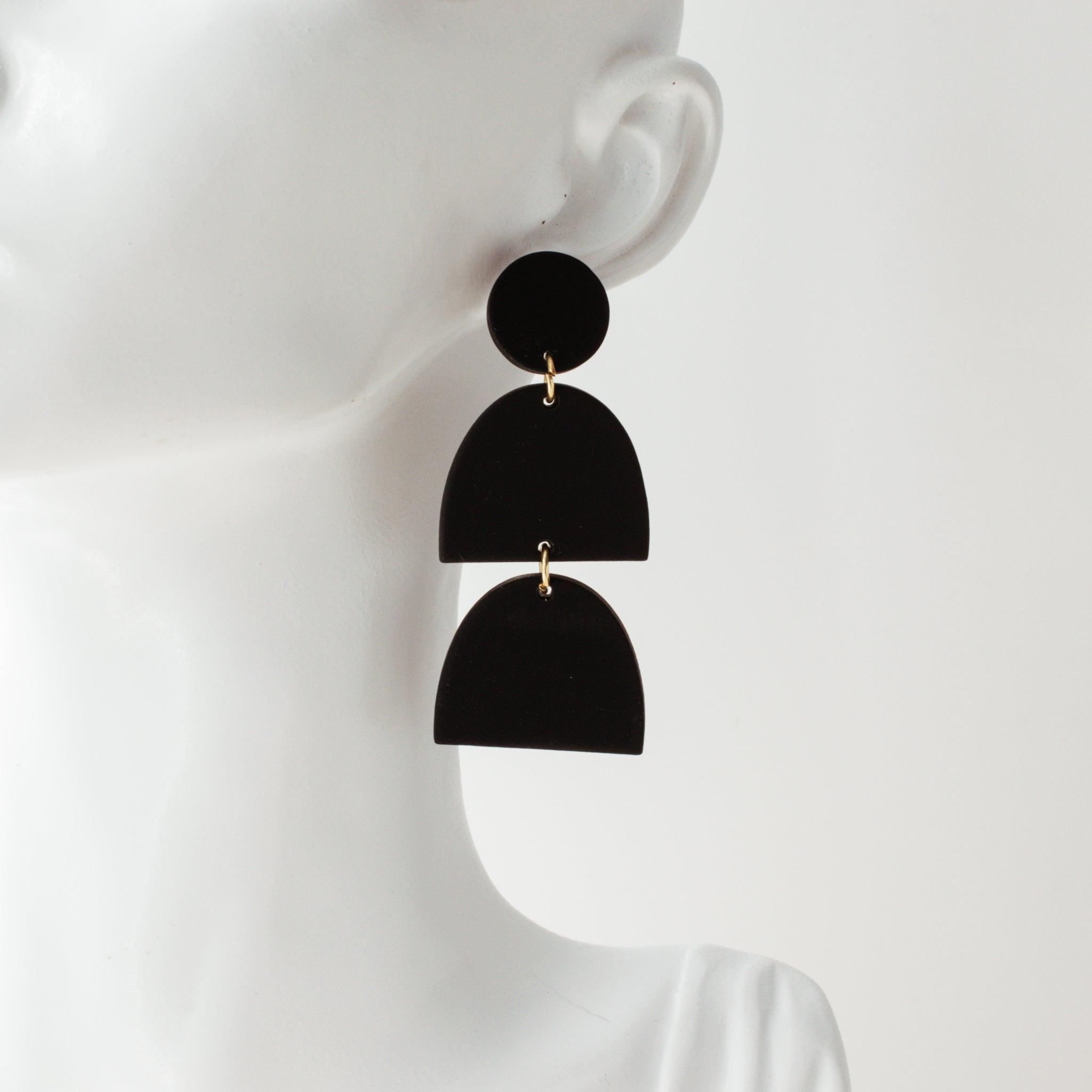 Black polymer clay drop earrings on a white mannequin