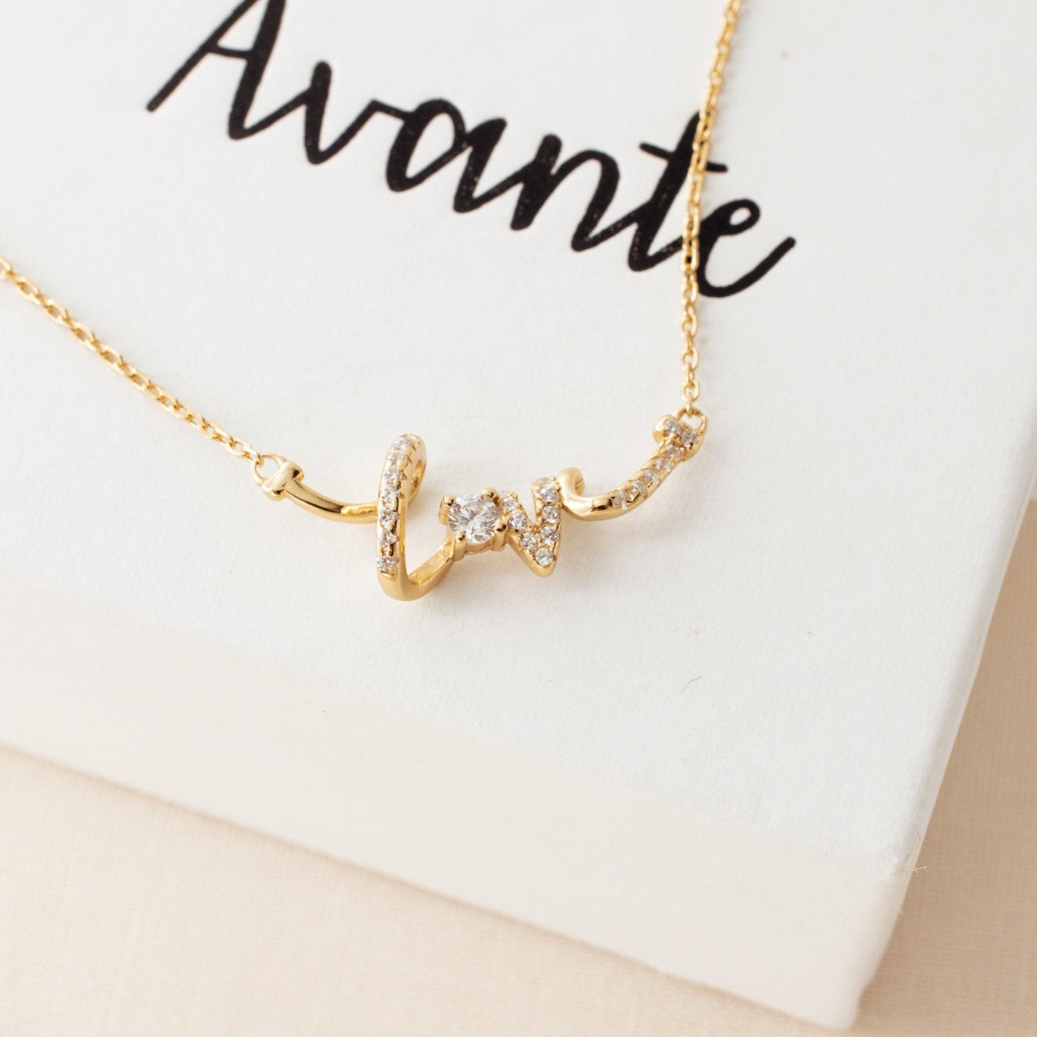 love pendant necklace on a gift box from avante jewel