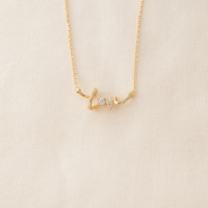 love pendant necklace on cream background