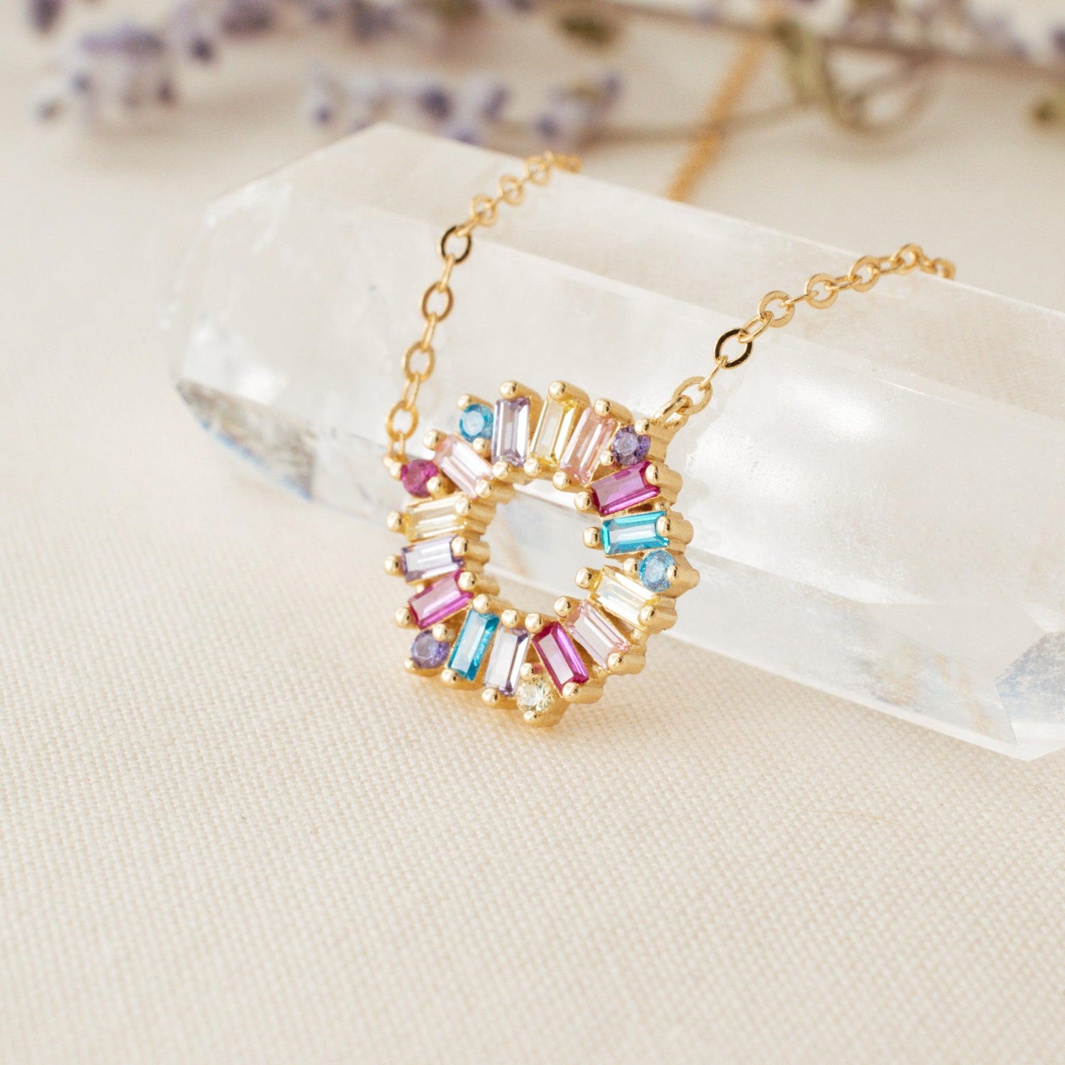 Multicolor Crystal Pendant Necklace on a clear crystal on a cream background