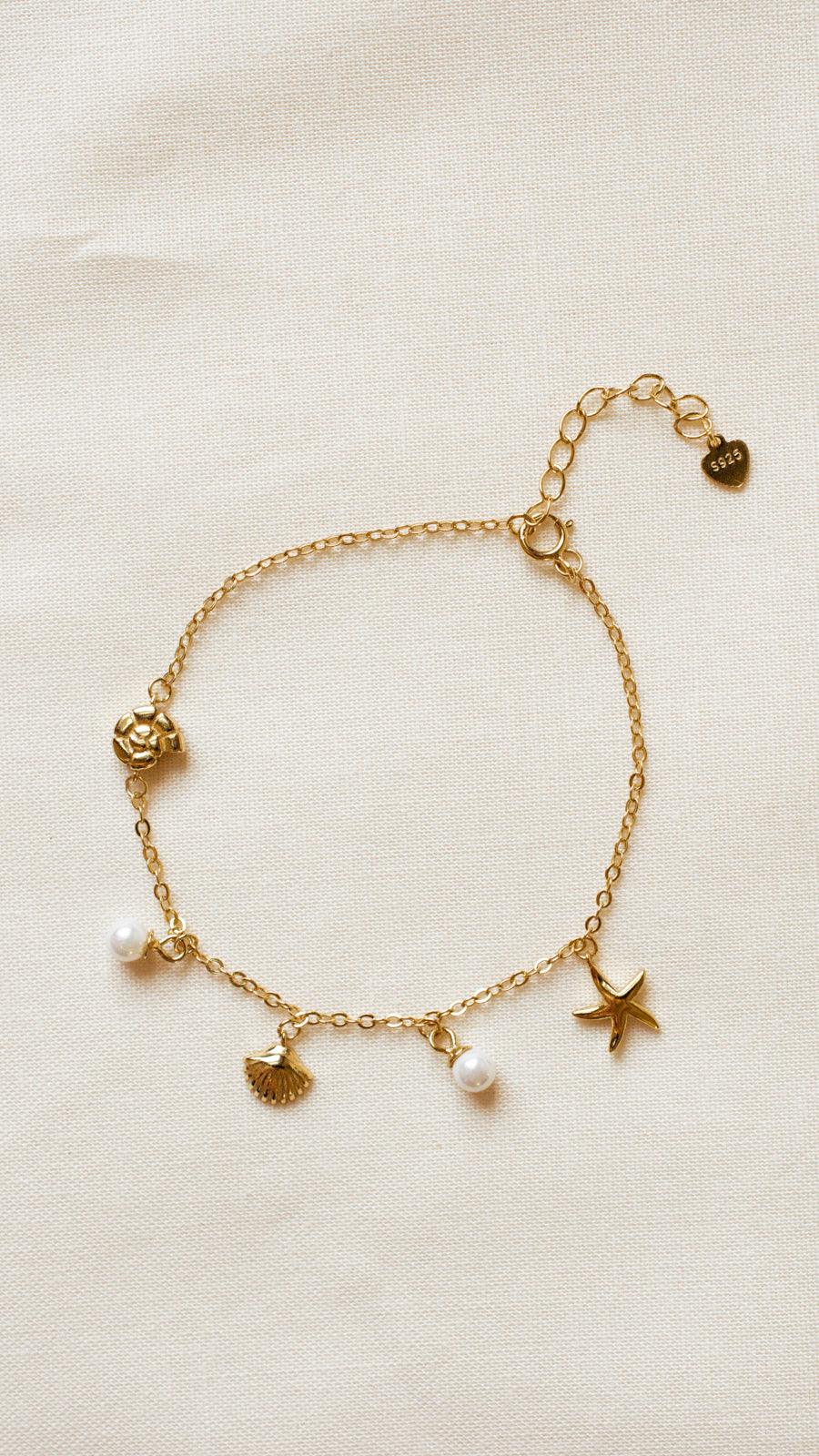 ocean charm bracelet display dainty shells, starfish and pearl charm