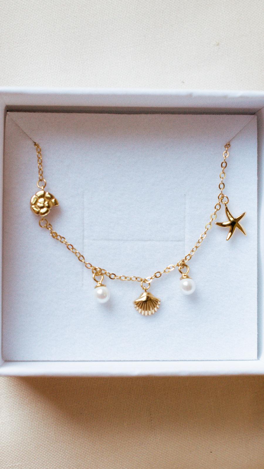 close-up photo of the ocean charm bracelet in a gift box