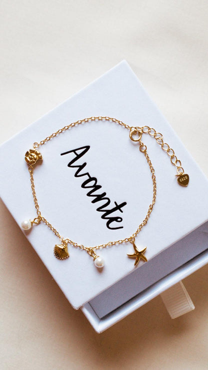 ocean charm bracelet on white jewelry box from Avante Jewelry